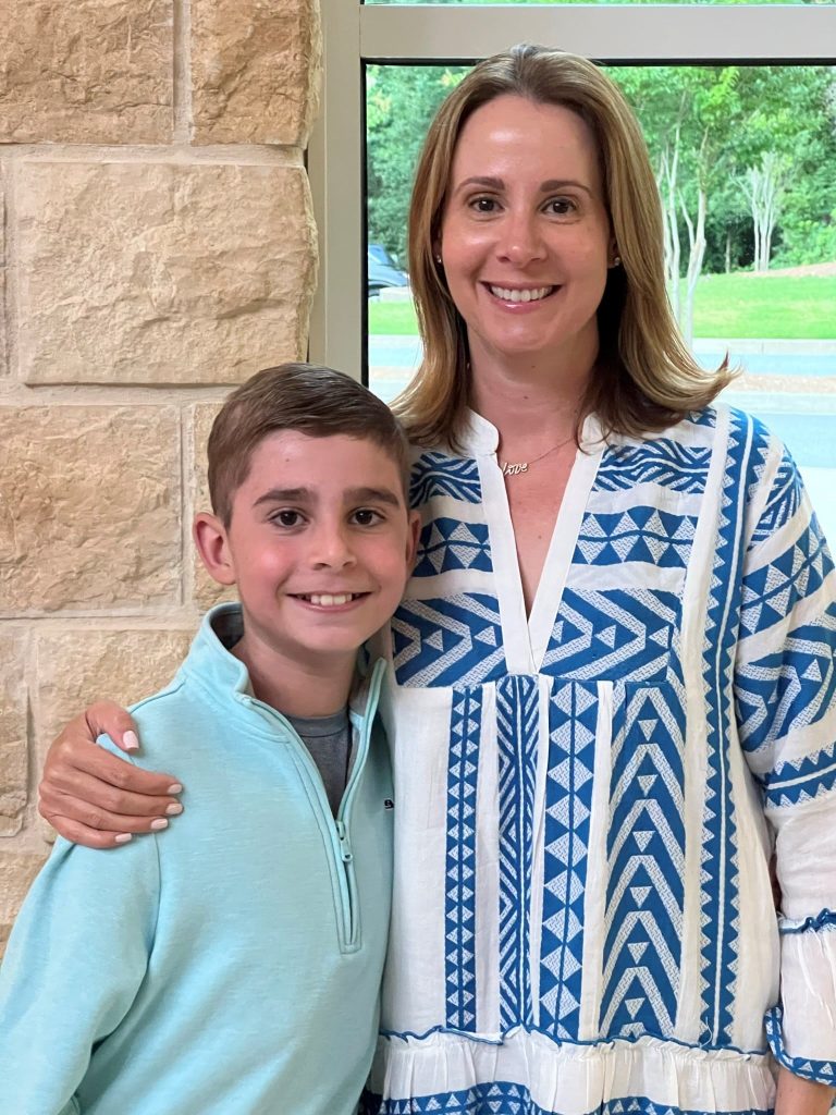 Noah Klein and his mother Elan standing side by side, her arm around his shoulders